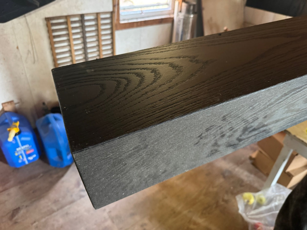 Black-stained mantel beam end grain close-up